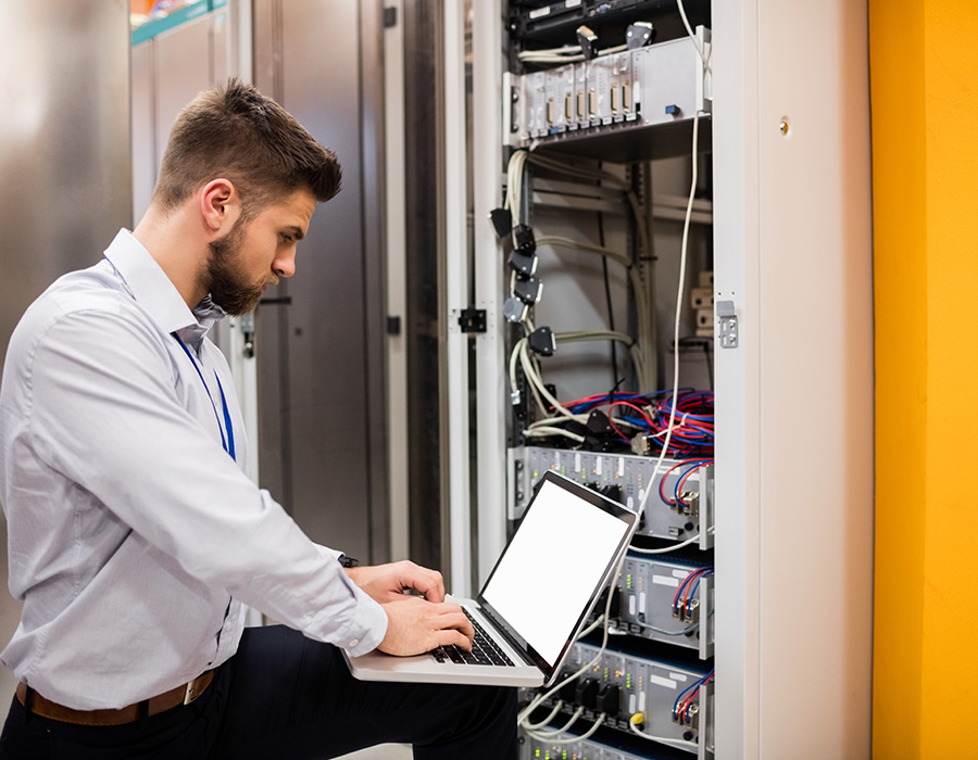 technician-using-laptop-while-analyzing-server-PQCV8JJ.jpg technician-using-laptop-while-analyzing-server-PQCV8JJ.jpg
