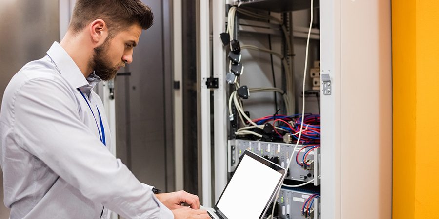 technician-using-laptop-while-analyzing-server-PQCV8JJ.jpg technician-using-laptop-while-analyzing-server-PQCV8JJ.jpg